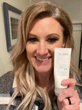 woman holding tube of toothpaste